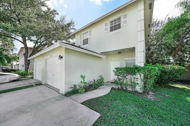 view of front of property with a garage and a front lawn