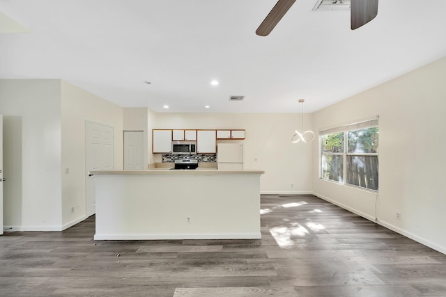 kitchen featuring a center island, dark wood-type flooring, and white refrigerator