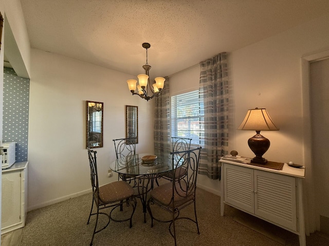 carpeted dining room featuring a textured ceiling and a notable chandelier