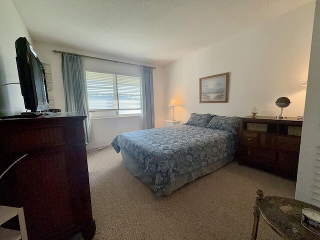 carpeted bedroom featuring a textured ceiling