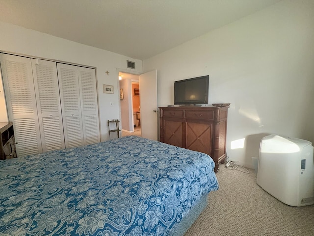 bedroom with light carpet and a closet