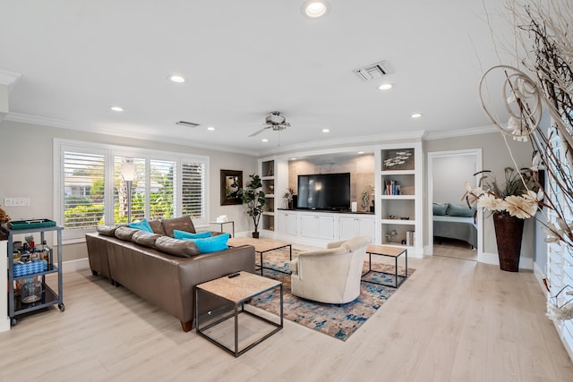 living room with light hardwood / wood-style floors, ceiling fan, and crown molding