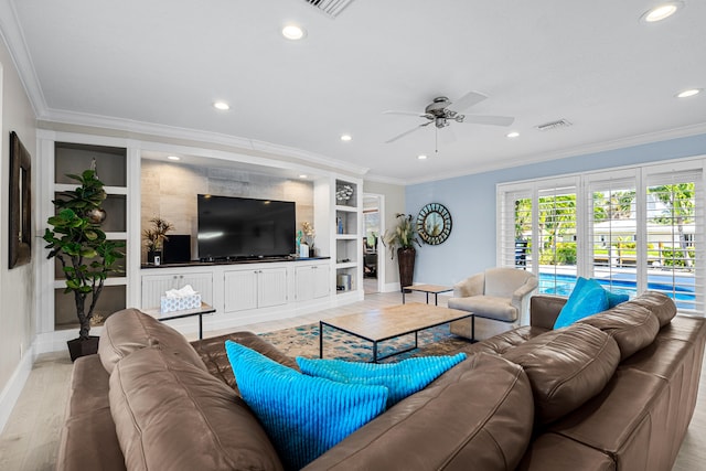 living room with built in shelves, light hardwood / wood-style floors, crown molding, and ceiling fan