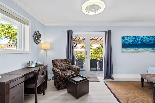 office featuring light hardwood / wood-style floors, ornamental molding, a wealth of natural light, and french doors