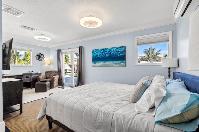 bedroom featuring a textured ceiling, light colored carpet, crown molding, and a wall mounted AC