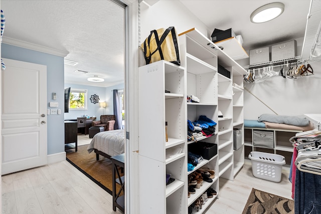 spacious closet with hardwood / wood-style floors