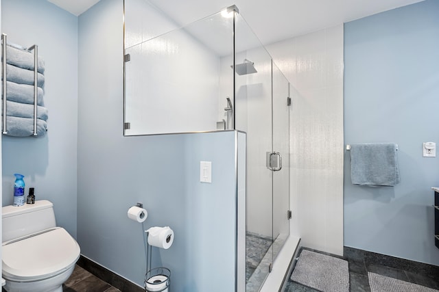 bathroom with toilet and a shower with door