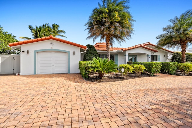 mediterranean / spanish house featuring a garage