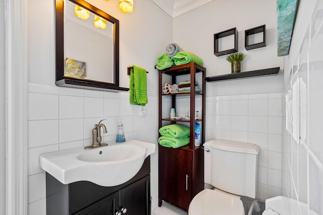 bathroom featuring vanity, toilet, tile walls, and crown molding