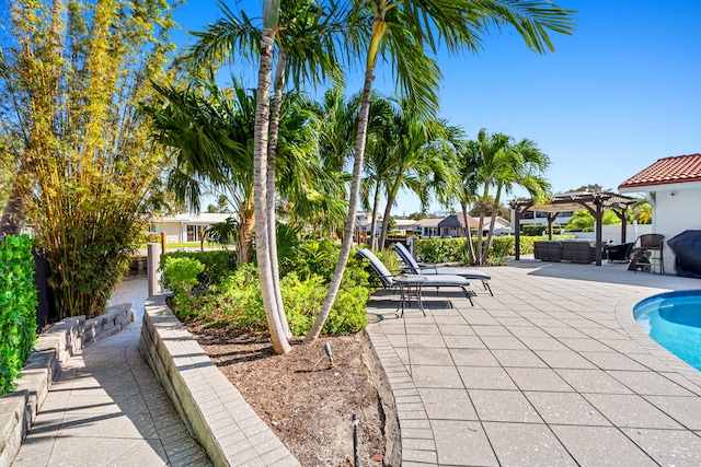 view of swimming pool featuring an outdoor living space, a pergola, and a patio area