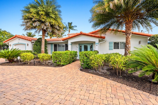 mediterranean / spanish home with a garage