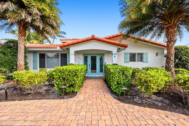 mediterranean / spanish house featuring french doors