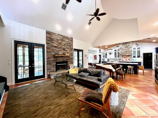 tiled living room with french doors, high vaulted ceiling, ceiling fan, and a healthy amount of sunlight