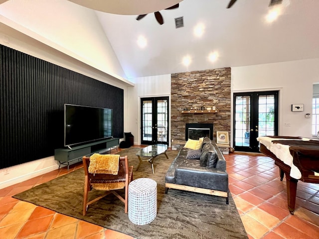 tiled living room featuring high vaulted ceiling, ceiling fan, and french doors