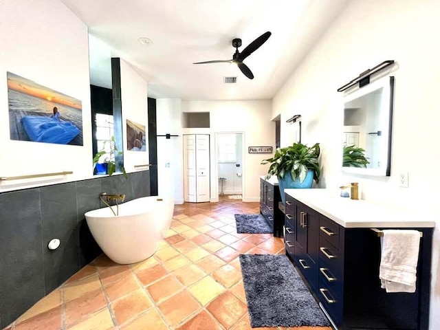 bathroom with ceiling fan, separate shower and tub, vanity, and tile patterned floors