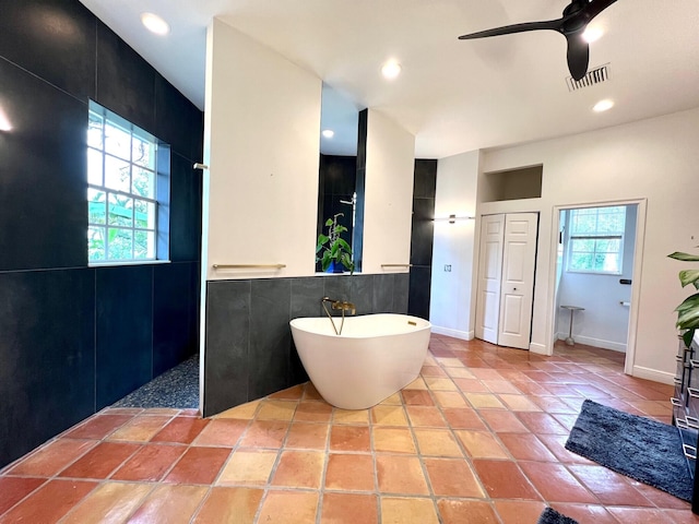 bathroom featuring tile patterned flooring, ceiling fan, and independent shower and bath