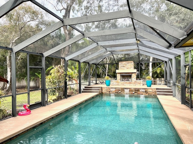 view of swimming pool with a patio area, pool water feature, and an outdoor stone fireplace