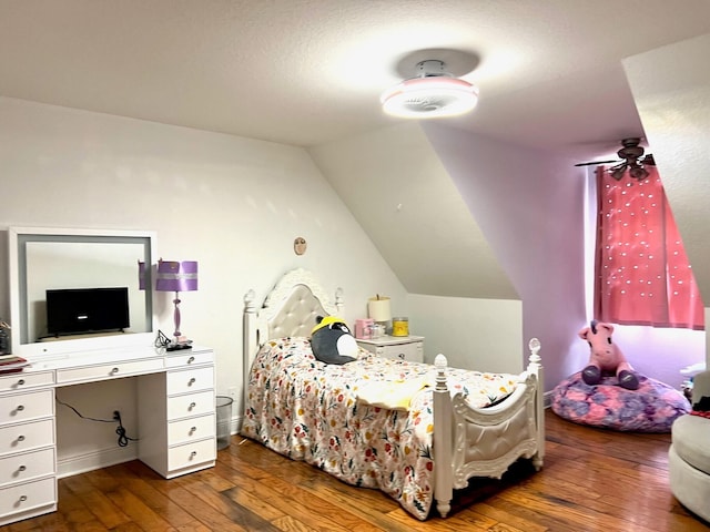 bedroom with lofted ceiling and dark wood-type flooring