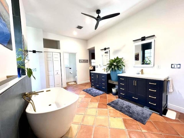 bathroom featuring ceiling fan, tile patterned flooring, vanity, and a bathing tub