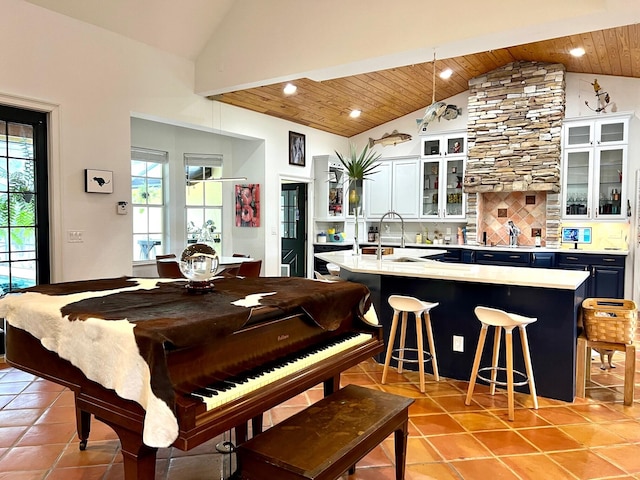 miscellaneous room with lofted ceiling, light tile patterned flooring, wooden ceiling, and sink