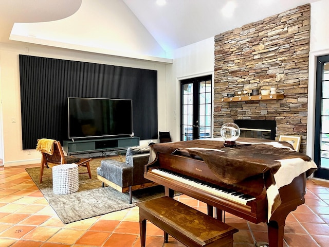 miscellaneous room with high vaulted ceiling, tile patterned flooring, french doors, and a fireplace