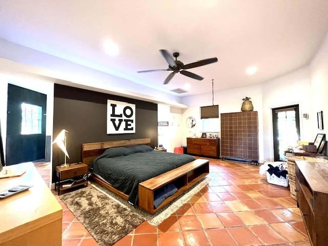 tiled bedroom featuring ceiling fan