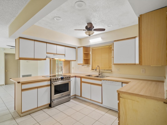 kitchen featuring kitchen peninsula, stainless steel electric range oven, white dishwasher, and white cabinets