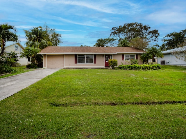 ranch-style home with a garage and a front lawn