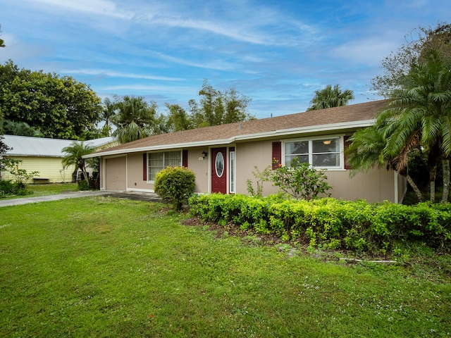 single story home featuring a garage and a front yard