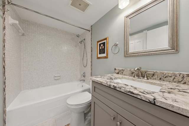 full bathroom with vanity, tile patterned flooring, toilet, and tiled shower / bath