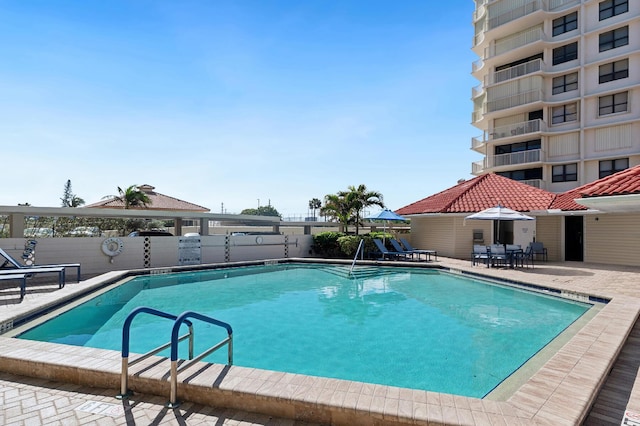 view of swimming pool with a patio