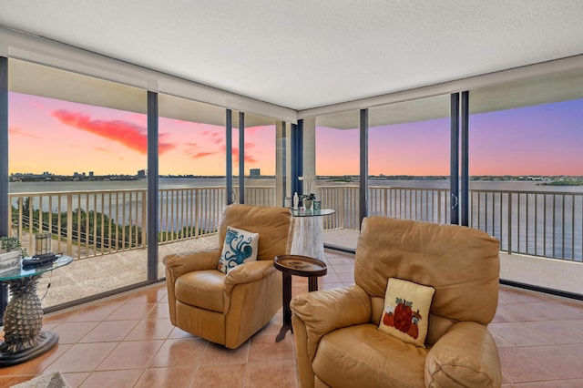 sunroom / solarium featuring a water view