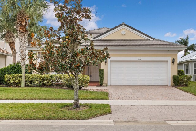 view of front facade with a garage and a front lawn