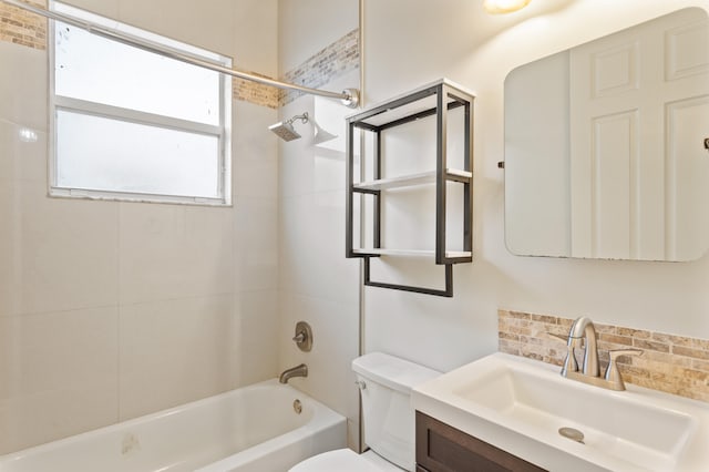 full bathroom with tasteful backsplash, toilet, vanity, and tiled shower / bath