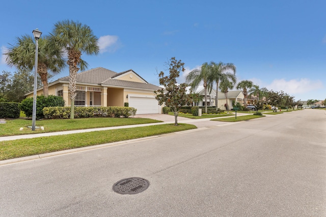 view of front of home featuring a garage and a front lawn