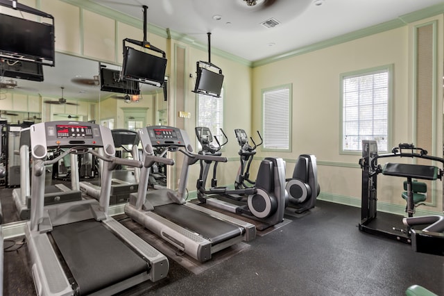 gym with ceiling fan and crown molding