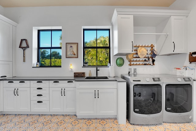 laundry room featuring sink, cabinets, and independent washer and dryer