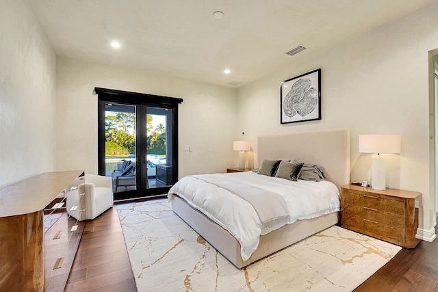 bedroom with hardwood / wood-style floors and access to outside