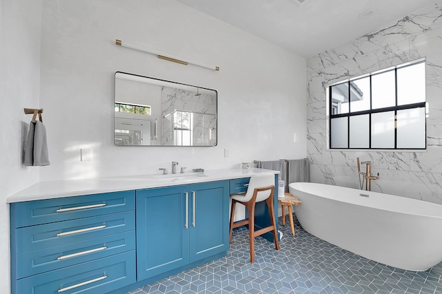 bathroom with tile patterned flooring, a healthy amount of sunlight, a bath, and tile walls