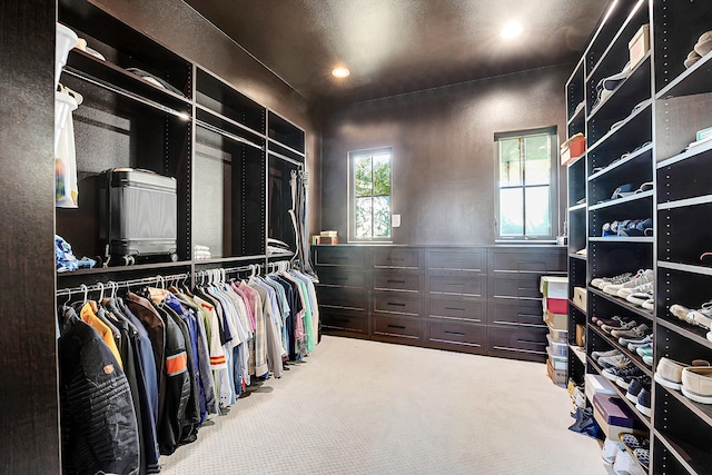 walk in closet with carpet flooring