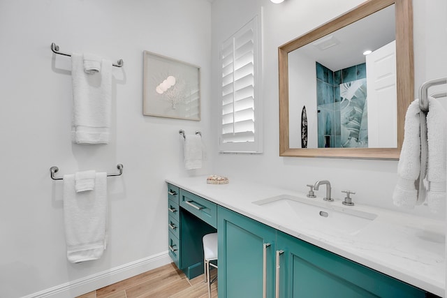 bathroom featuring vanity, wood-type flooring, and walk in shower