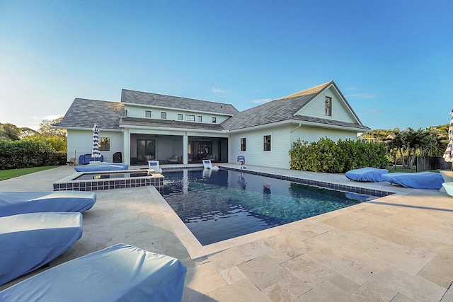 view of swimming pool with a jacuzzi and a patio