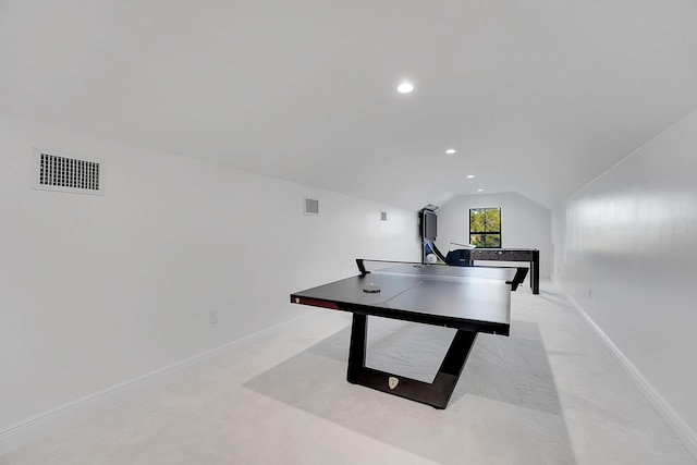 recreation room with light carpet and vaulted ceiling