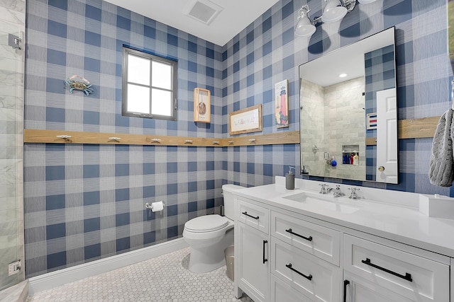 bathroom with tile patterned flooring, vanity, and toilet