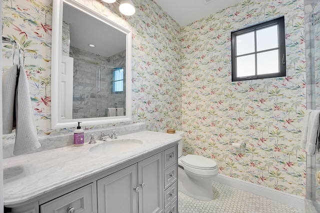 bathroom featuring tile patterned flooring, vanity, toilet, and a shower with shower door