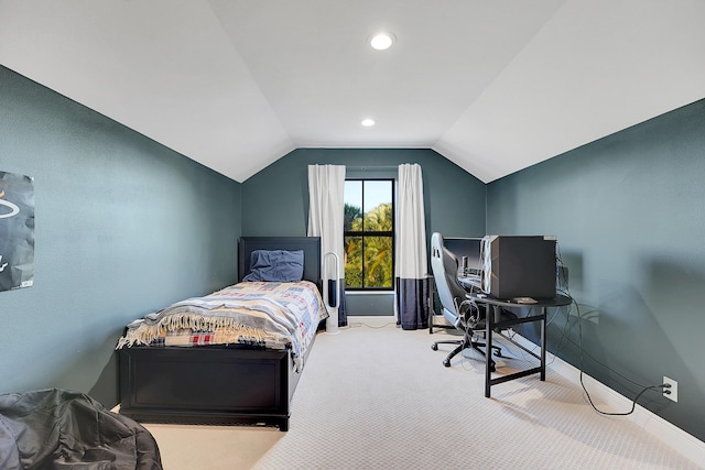 bedroom featuring lofted ceiling and light carpet