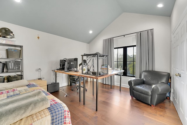 bedroom with dark hardwood / wood-style floors and vaulted ceiling