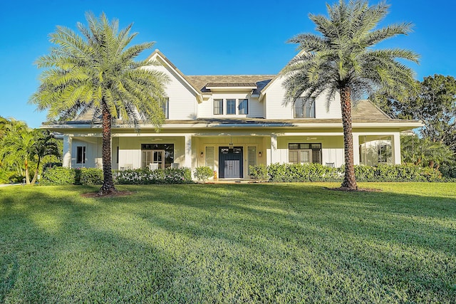 view of front of property featuring covered porch and a front yard