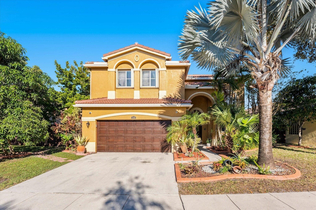 mediterranean / spanish-style home with a garage