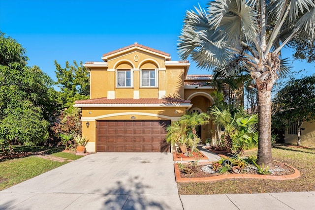 mediterranean / spanish-style home with a garage